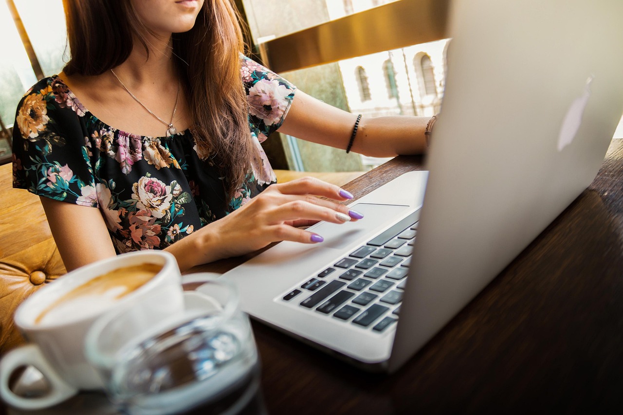 Woman, laptop, desk — 4 Answers to your Questions about WordPress Reset