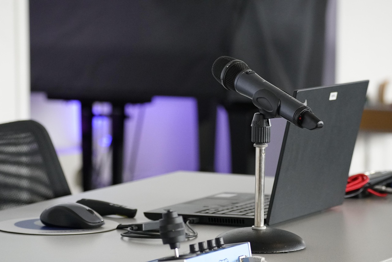 Laptop, conference table, mouse — Advantages of AdWords Services