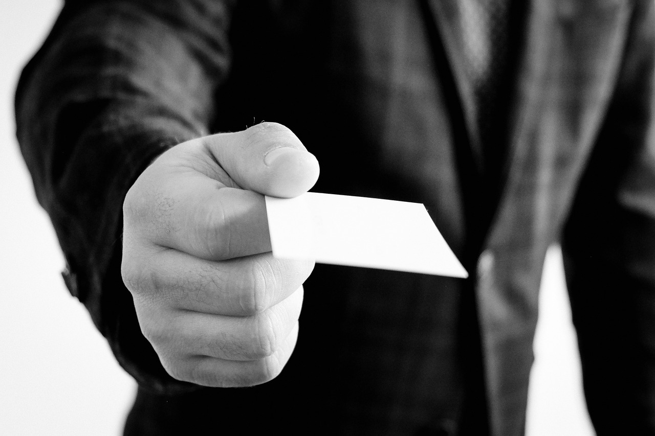 Business card, hand, jacket — Using a loan application form Being an Evaluation Tool